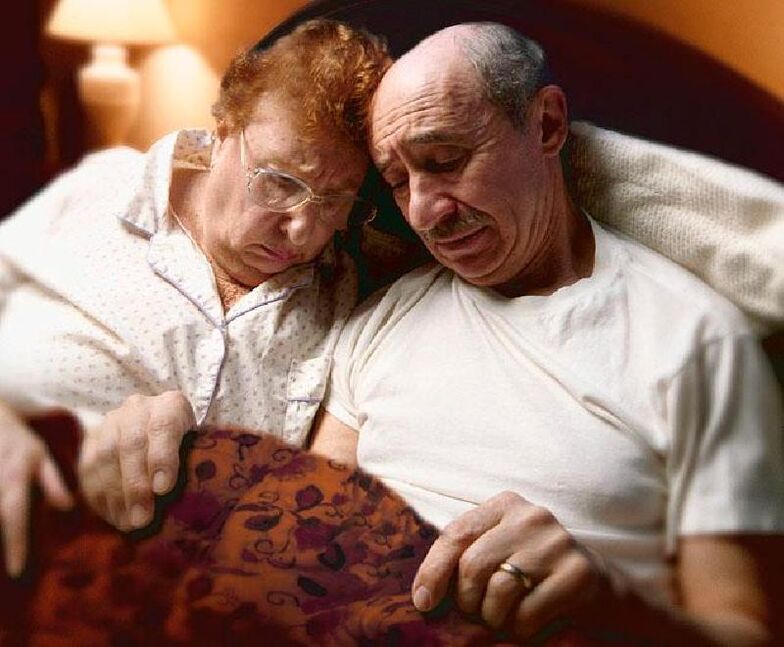 adult pair in bed