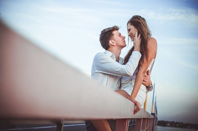A woman in the arms of a man of excellent potency